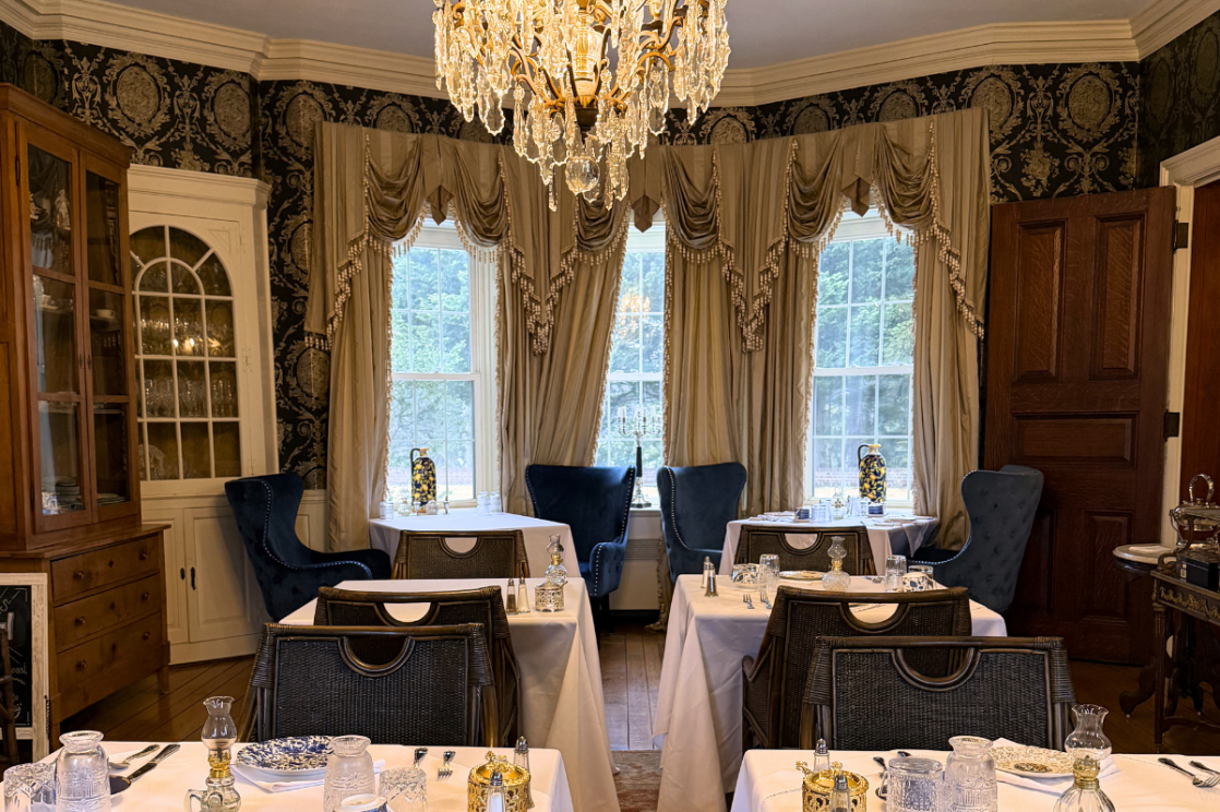 view of the tacaro estate dining room with original taffeta curtains